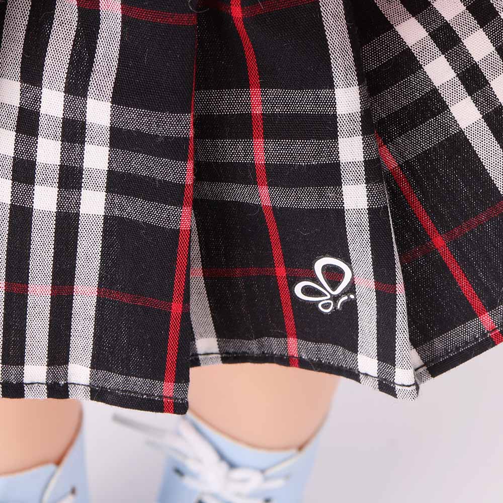 Detailed close-up of the classic houndstooth pattern on Akiko doll's pleated skirt