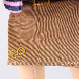 Texture and pleat detail of Lucy doll's brown removable skirt