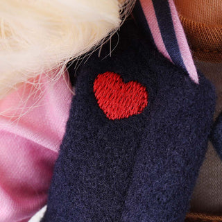 Close-up of heart pattern embroidery on Lucy doll's clothing
