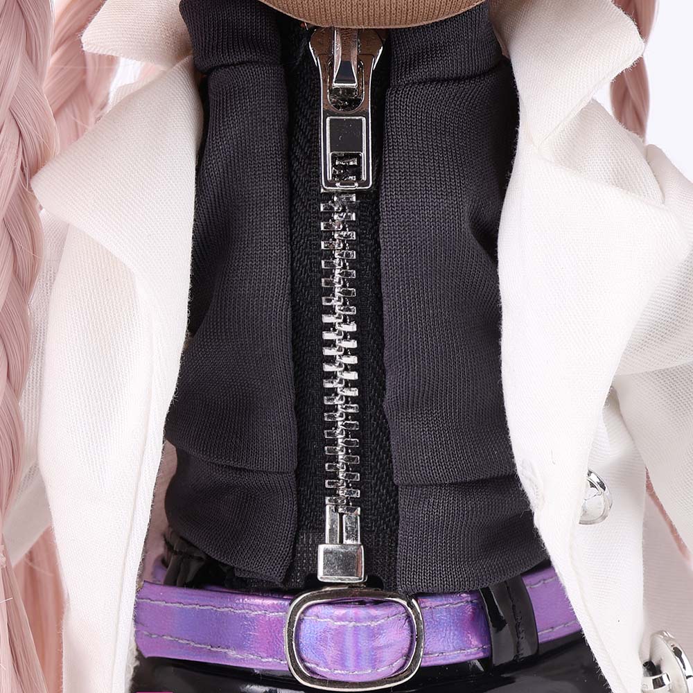 Close-up showing fabric texture and design details of Naya doll's white jacket