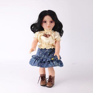Front view of WeGirls Pastry Chef Wanru doll with black curly hair, wearing a sweet yellow top and denim cake-layer skirt.
