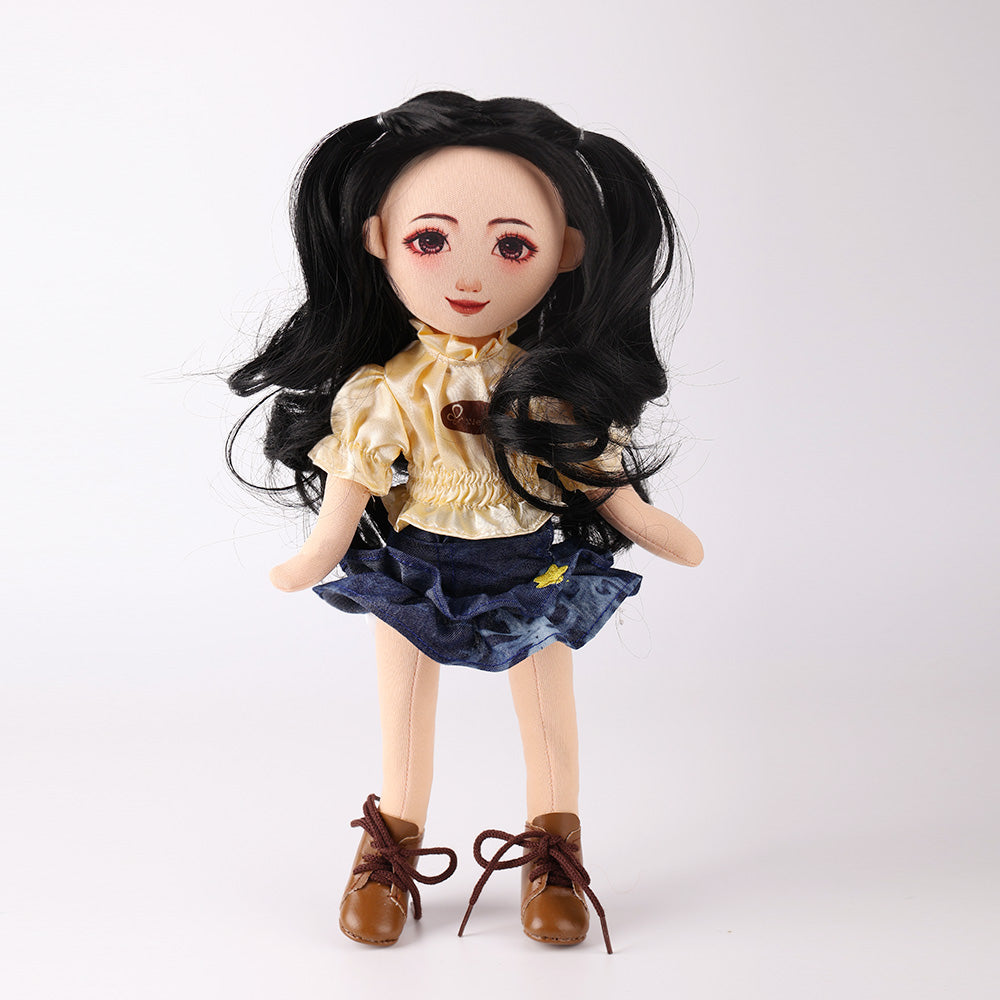 Front view of Wanru doll with black curly hair in yellow puff sleeve tee and denim cake skirt