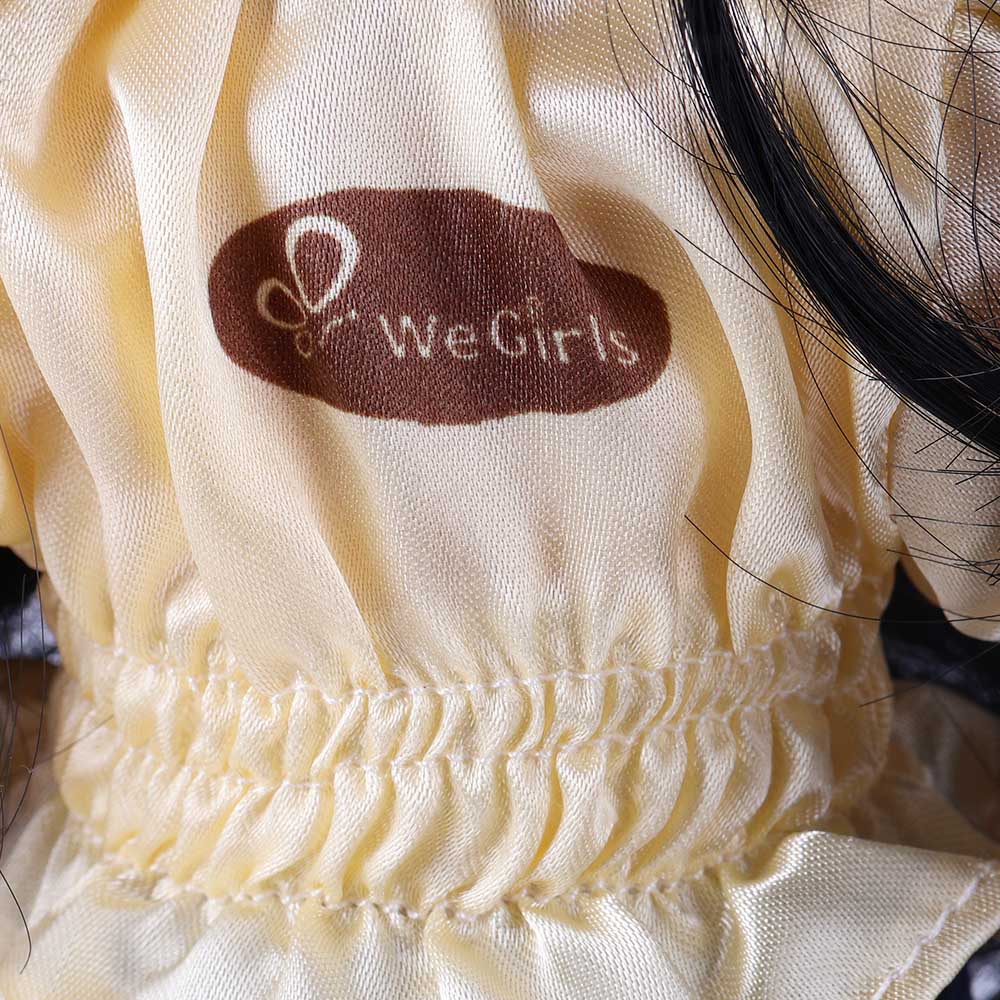 Close-up of WeGirls logo embroidery on Wanru doll's yellow tee
